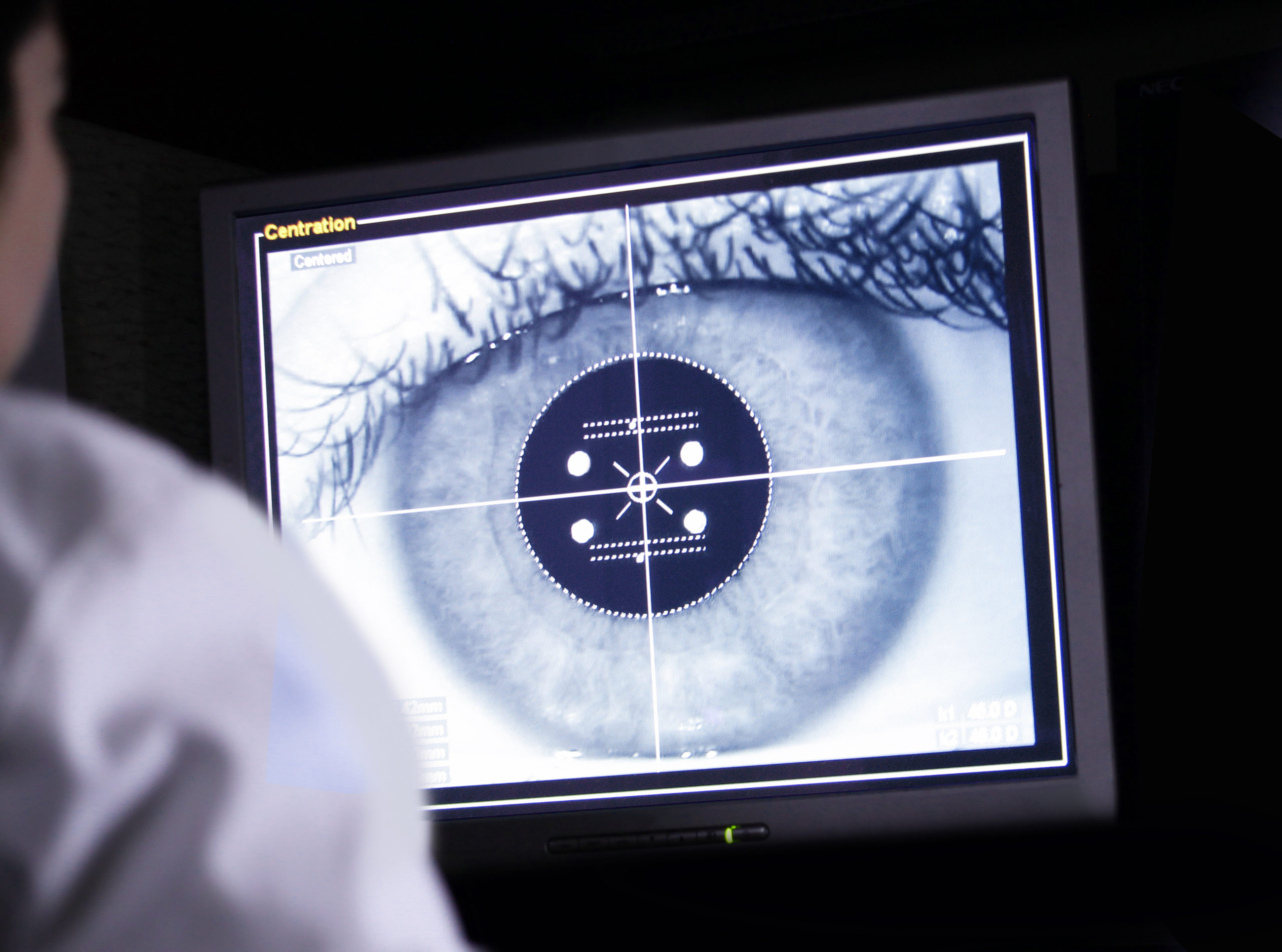doctor examining eye scan on computer