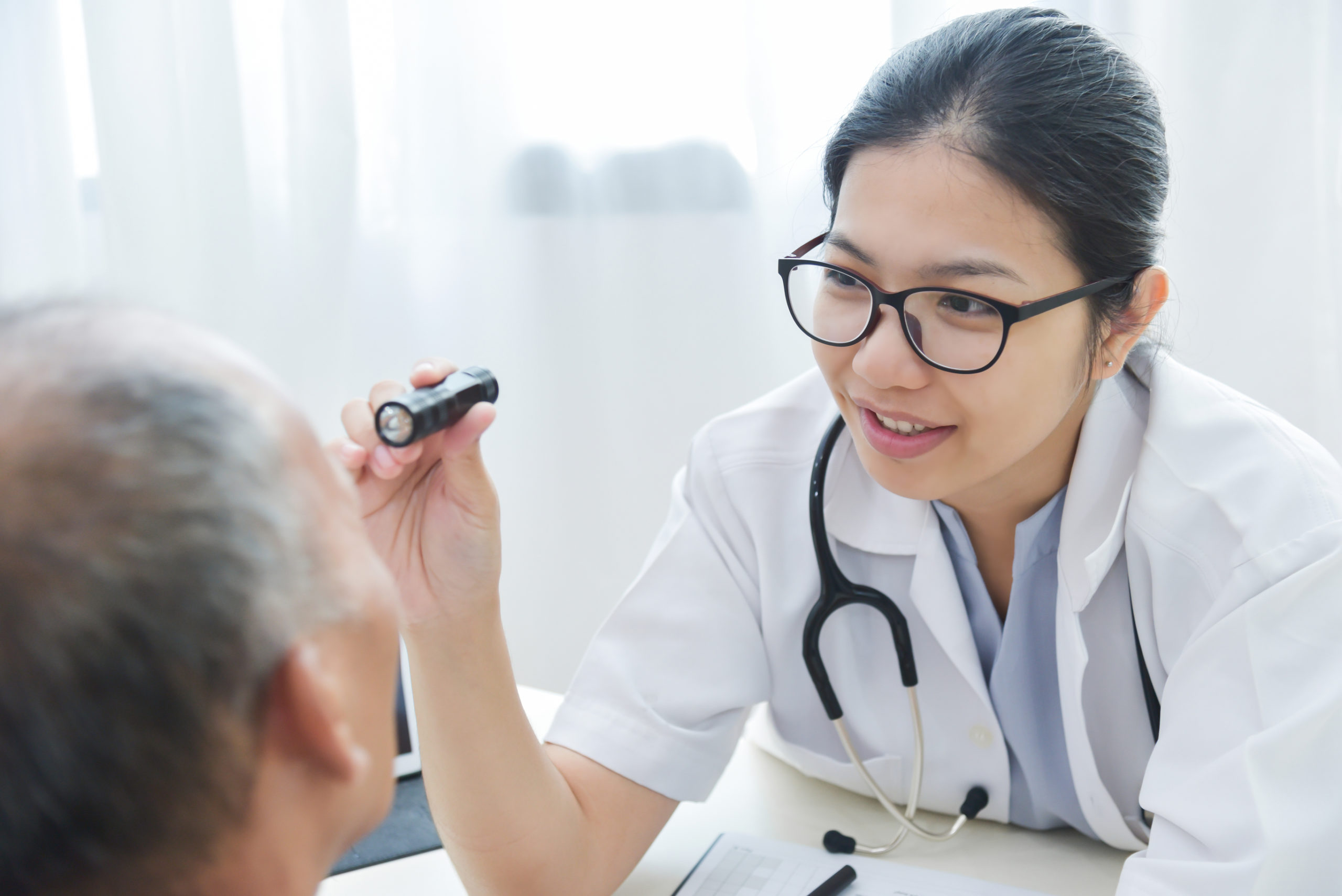 doctor examining patient's eye