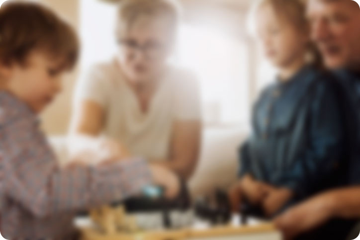 very blurry photo of family playing board game