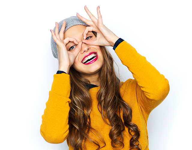 Headshot of corneal conditions eye care patient in yellow sweater