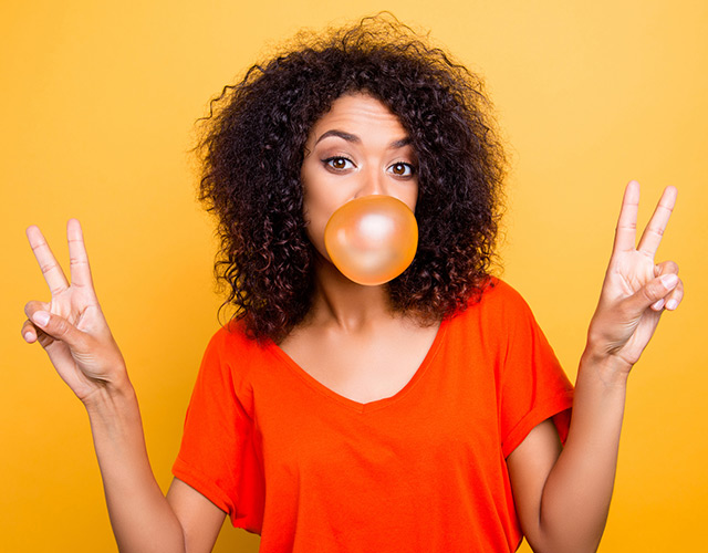 Dallas LASIK eye surgery patient blowing bubble with gum