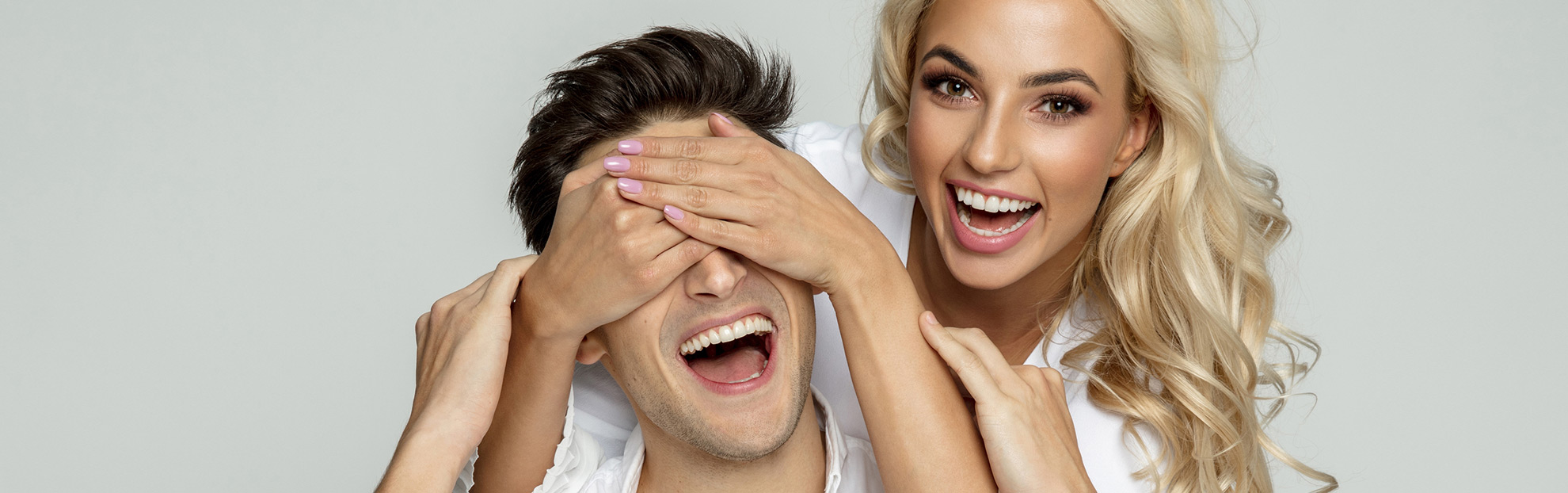 LASIK eye surgery patients covering eyes and laughing