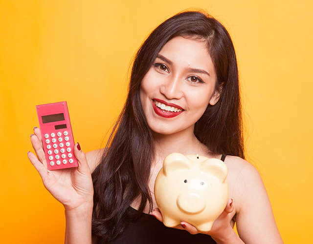 LASIK eye surgery patient with a piggy bank and calculator