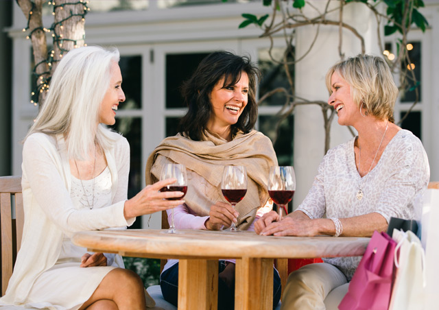 Female cataract surgery patient drinking wine with ladies