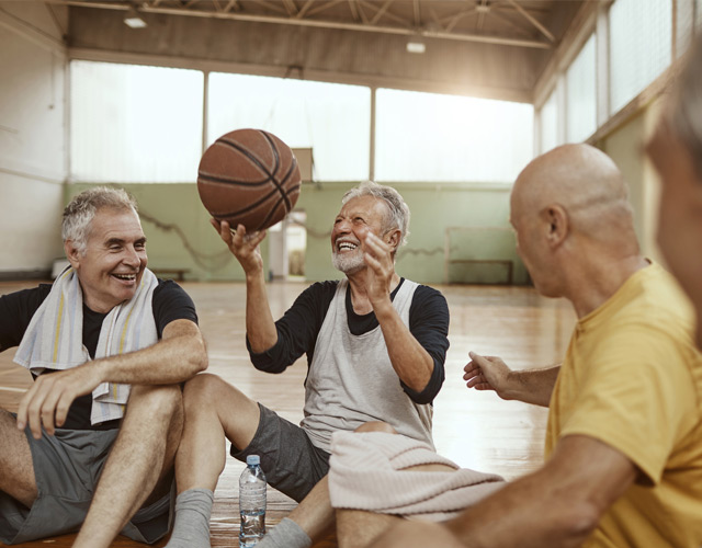 Older cataract surgery patients playing with basketball