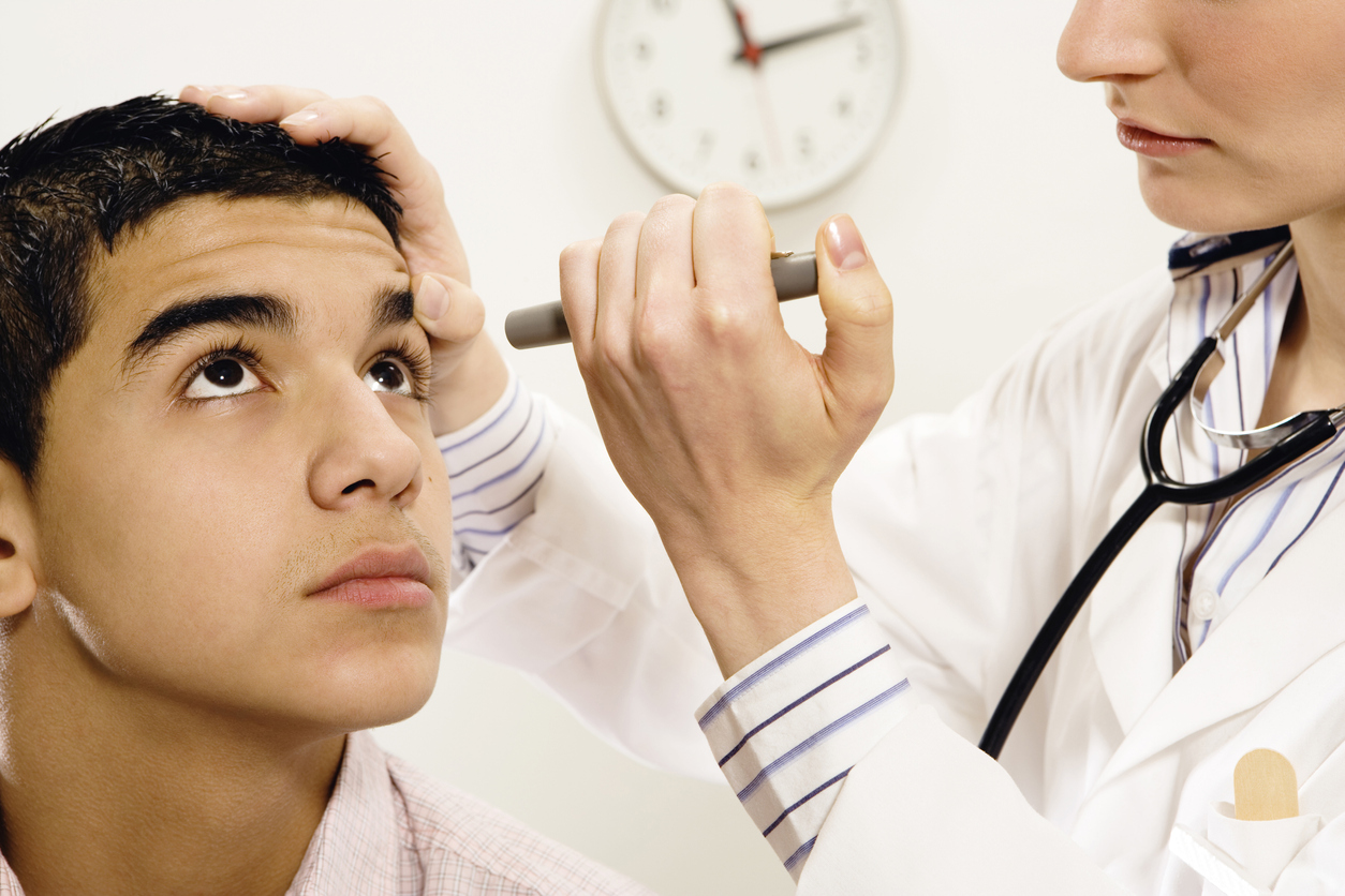 young man getting eye examined